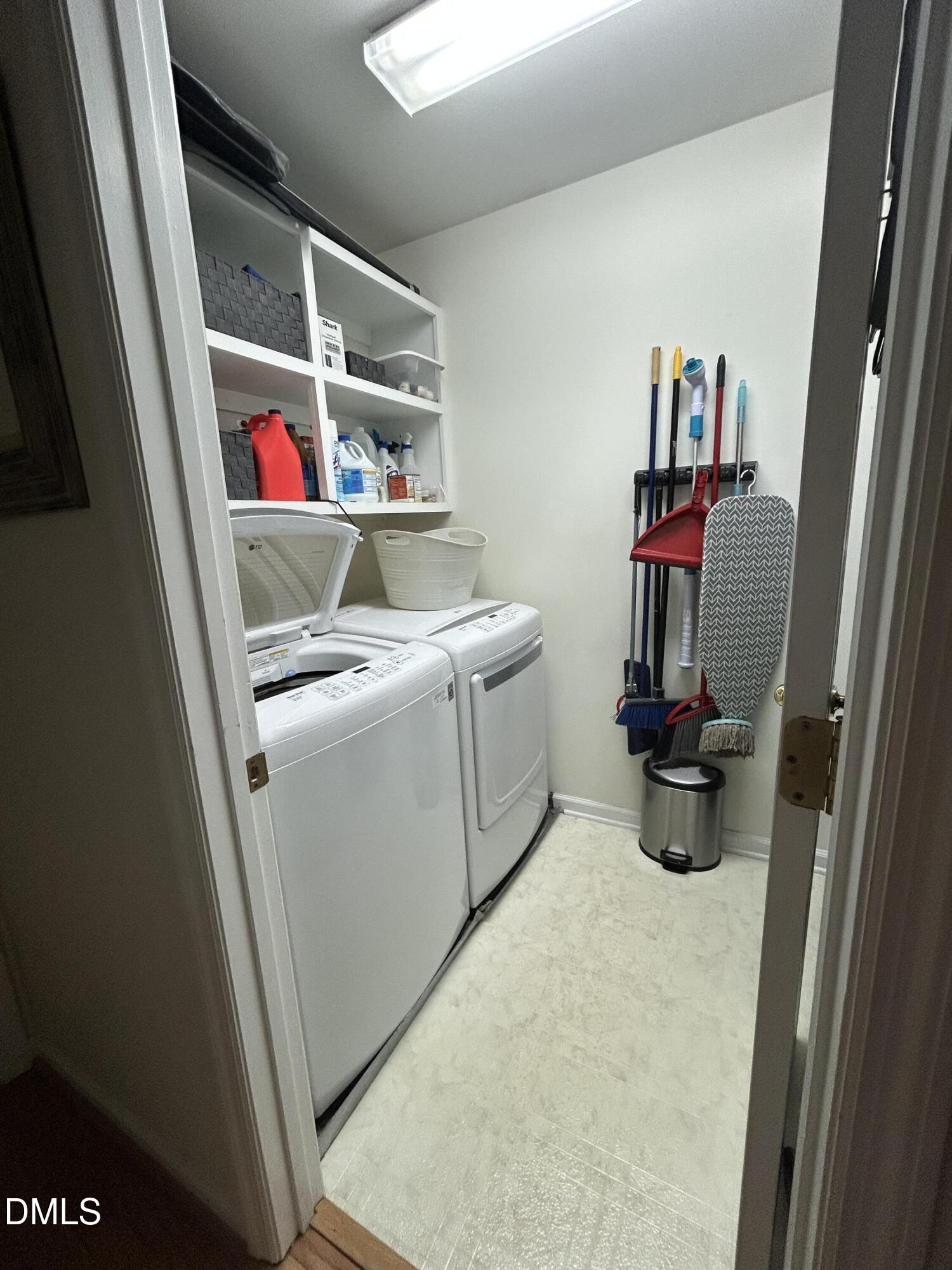 1214 Halcyon Place Rougemont, NC 27572 - Photo 29 of 69 a utility room with dryer washer and shoe rack
