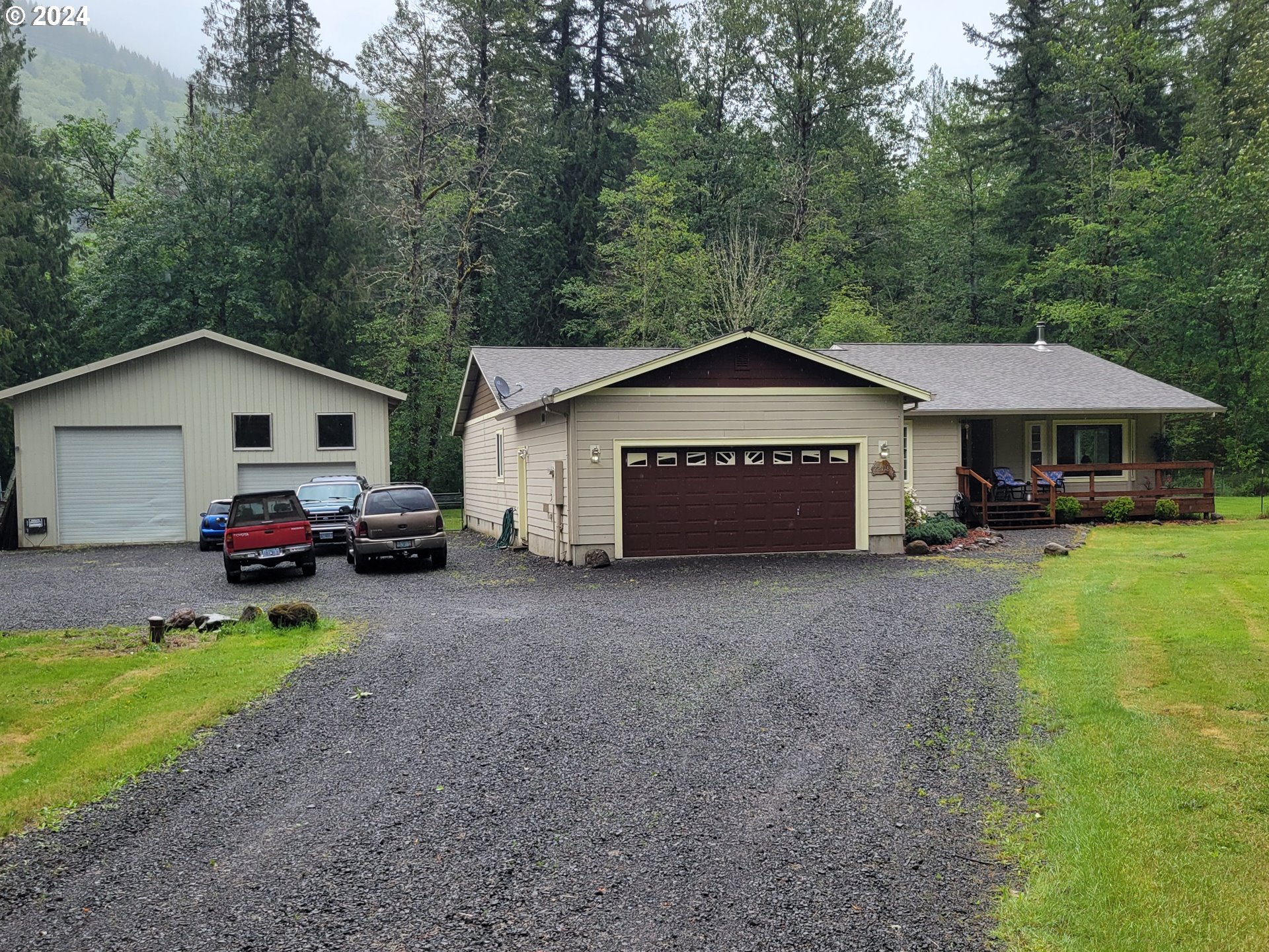 22118 East Yakima Lane Rhododendron, OR 97049 - Photo 2 of 31 a view of a house with a yard and large trees