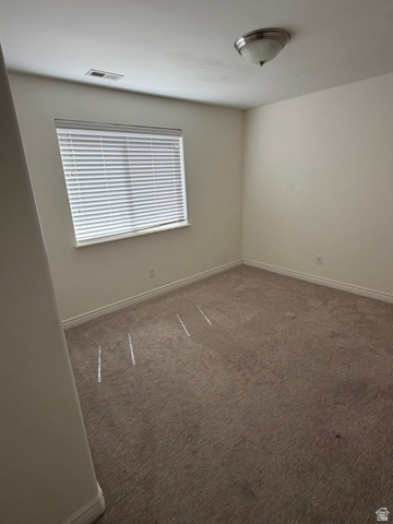 909 South Main Street, Unit F Layton, UT 84041 - Photo 8 of 20 Neutral-toned wall paint and matching carpet flooring