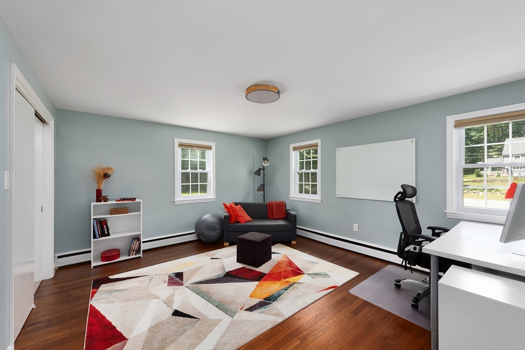 41 Woodcrest Road Boxford, MA 01921 - Photo 15 of 31 a living room with furniture gym equipment and a window