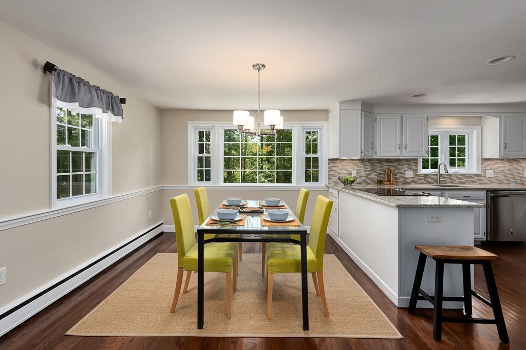 41 Woodcrest Road Boxford, MA 01921 - Photo 7 of 31 a kitchen with a table chairs a window and cabinets