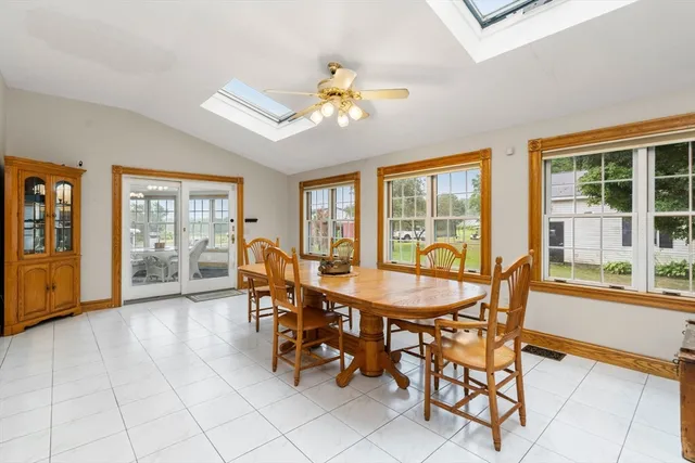 a dining room with furniture a chandelier and wooden floor