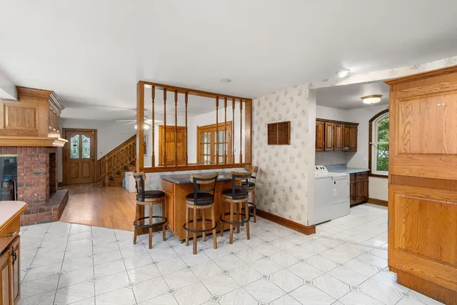 a living room with furniture a dining table and chairs with wooden floor