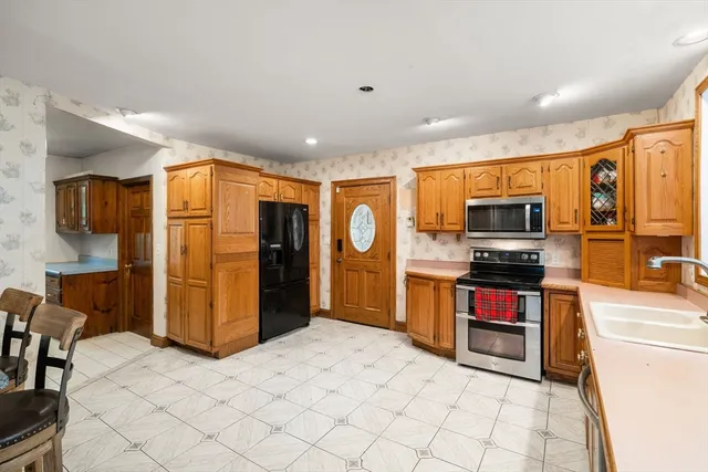 a kitchen with stainless steel appliances a refrigerator and a stove top oven