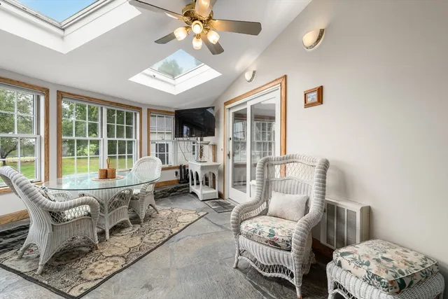 a living room with furniture and a floor to ceiling window