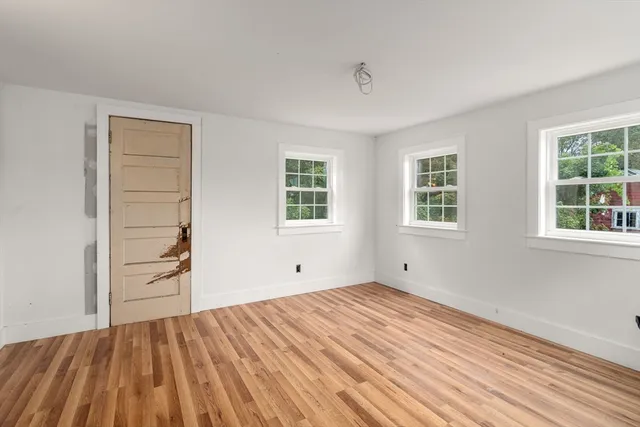 wooden floor in an empty room with a window