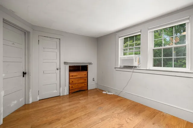 an empty room with windows and closet