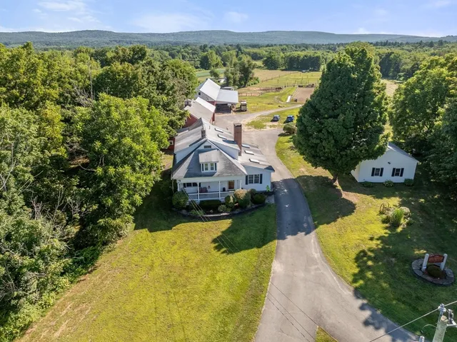 a view of a house with a yard and a large pool