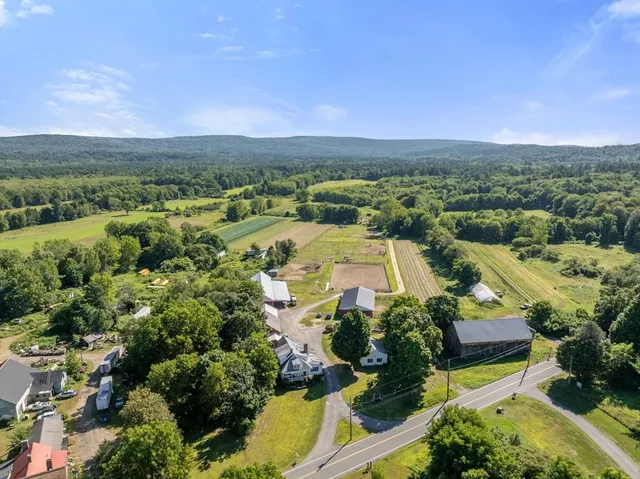 an aerial view of a houses with a yard