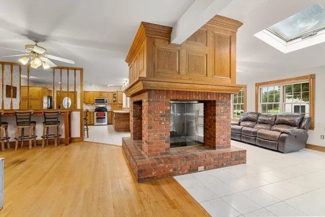 a living room with furniture a fireplace and a table