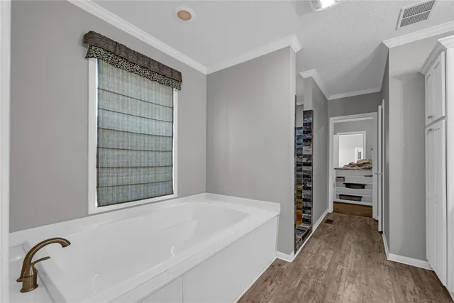a bathroom with a bathtub and a shower