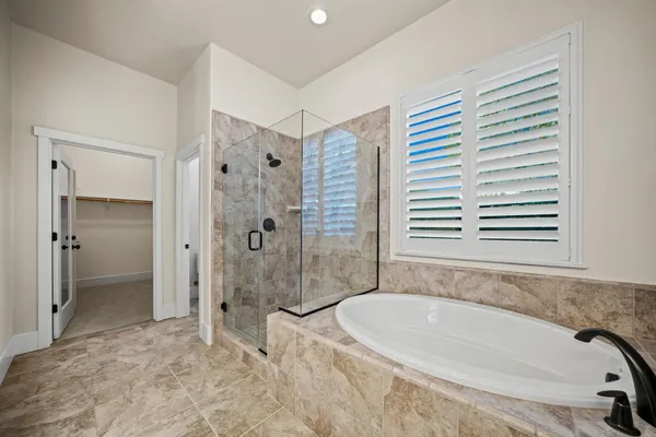 a bathroom with a tub and a shower