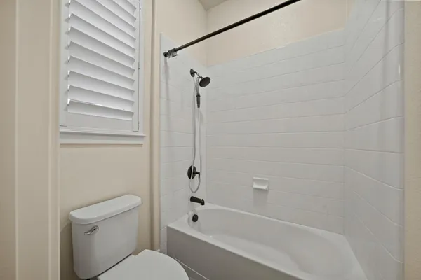 a bathroom with a toilet and a bathtub