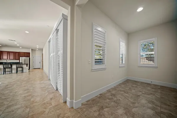 a view of a livingroom with kitchen and staircase