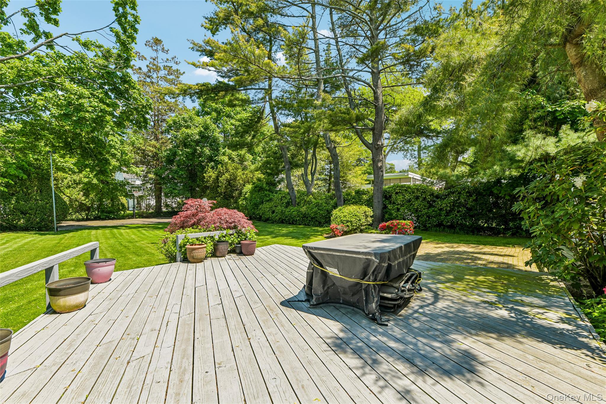 100 Hewlett Neck Road Woodmere, NY 11598 - Photo 40 of 45 a view of a wooden deck with furniture