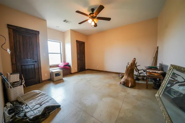 a bedroom with a bed and a refrigerator