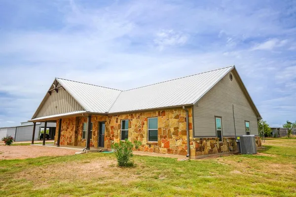 a front view of house with yard and swimming pool