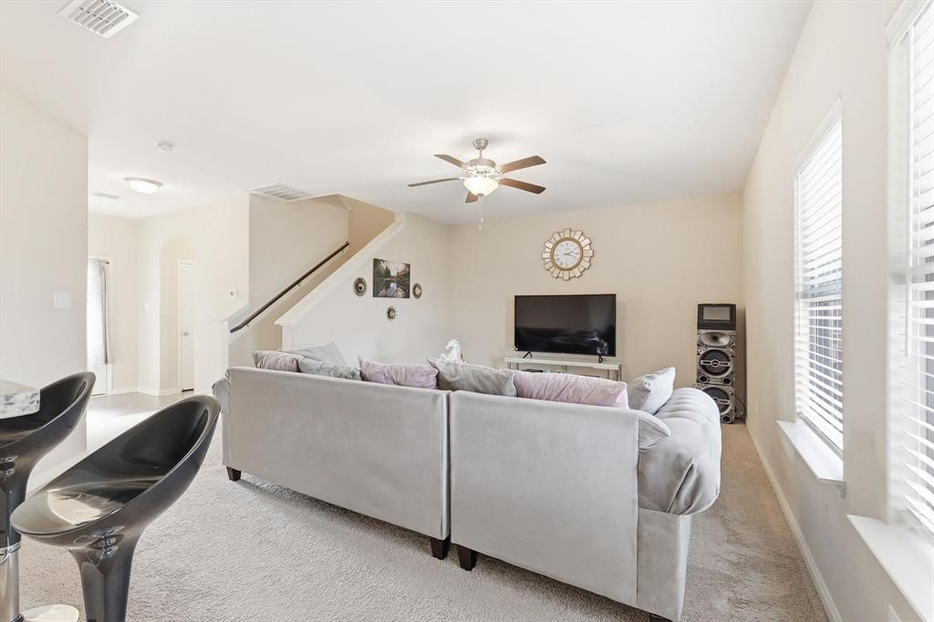 227 Curt Street Anna, TX 75409 - Photo 4 of 40 Living room with healthy amount of natural light, light carpet, and ceiling fan
