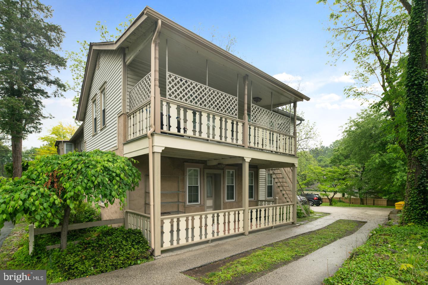 Part of a charming triplex with inviting porch.