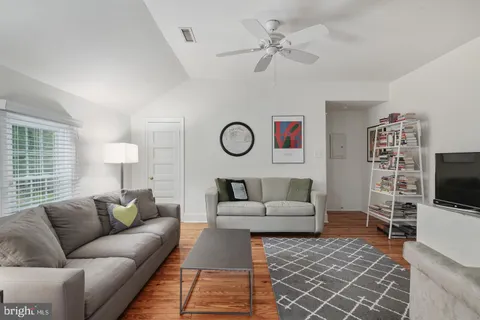 a living room with furniture a rug and a flat screen tv