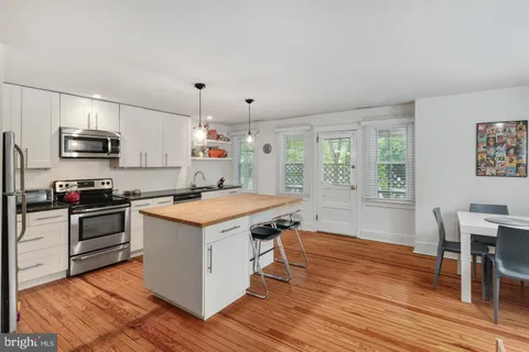 a kitchen with a stove a sink and a refrigerator