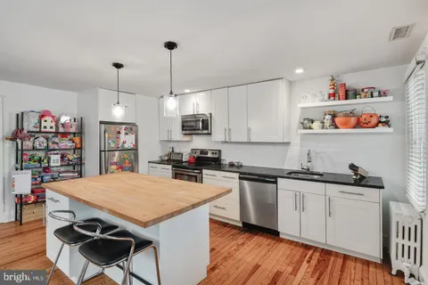 a kitchen with a sink a stove and cabinets