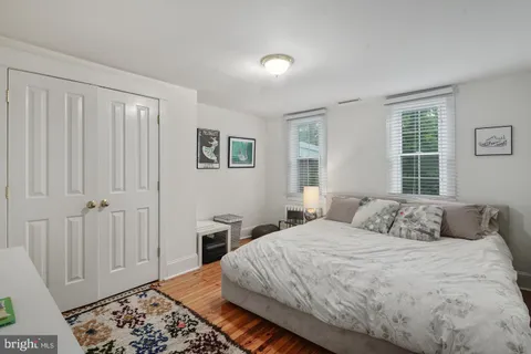 a bedroom with a bed and a window with rug