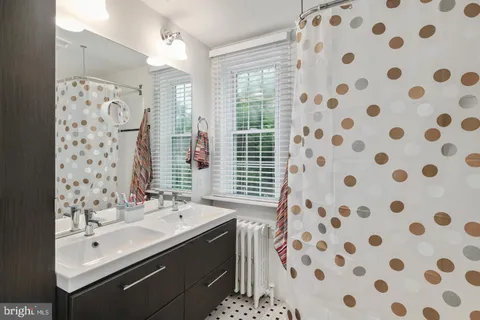 a bathroom with a sink mirror and shower