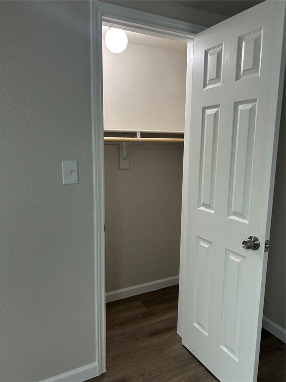 407 North Justin Avenue, Unit D Dallas, TX 75211 - Photo 6 of 15 an empty room with wooden floor and closet