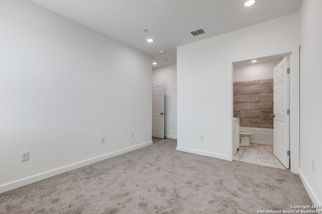 5415 Ingram Road, Unit 1203 San Antonio, TX 78228 - Photo 9 of 12 an empty room with cabinet and wooden door