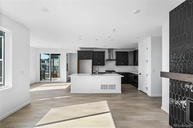 a view of a living room with a large window and a fireplace