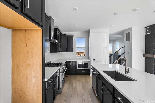 a kitchen with a sink stove and cabinets