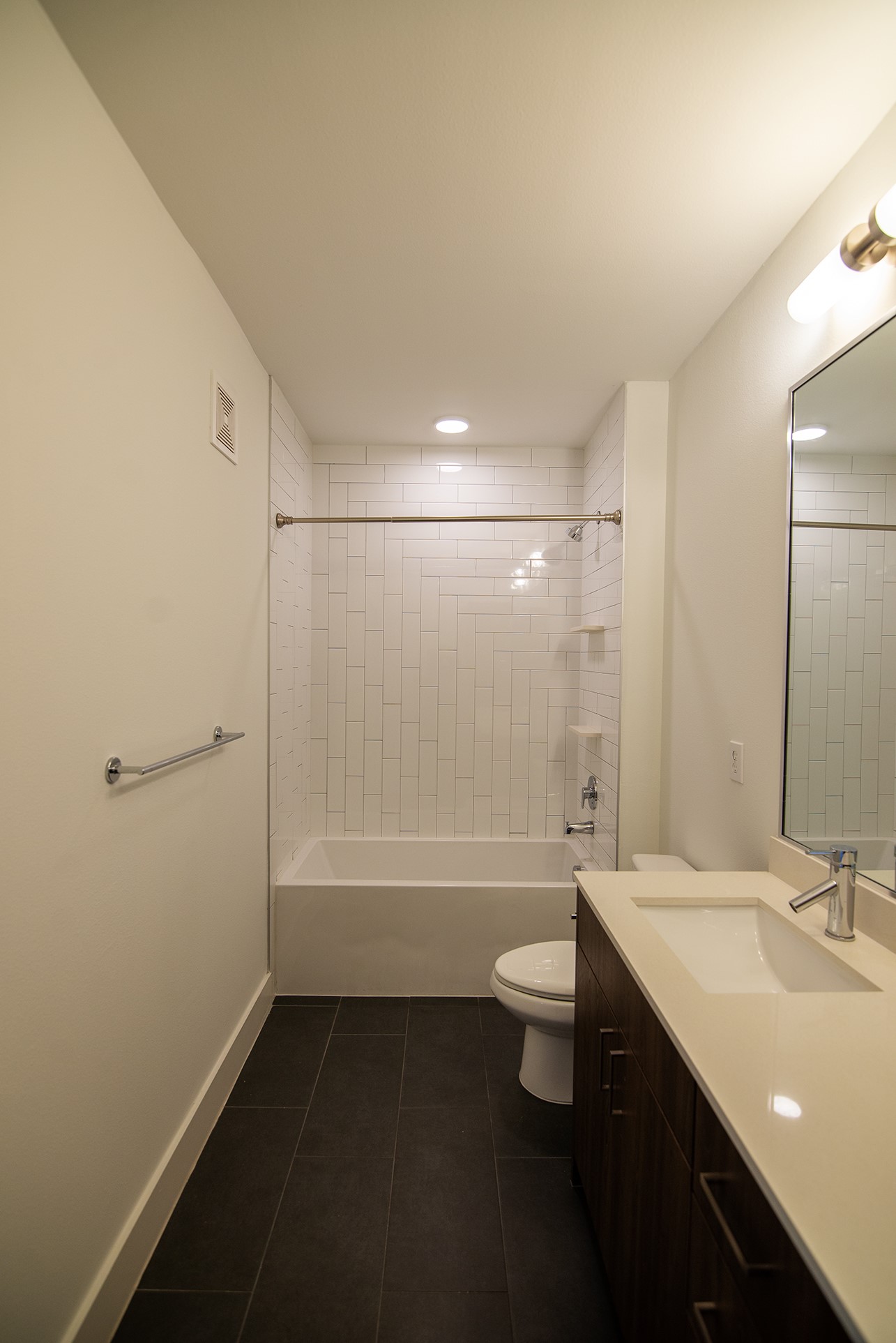 2213 Poquito Street, Unit 313 Austin, TX 78722 - Photo 14 of 26 a bathroom with a double vanity sink toilet and shower