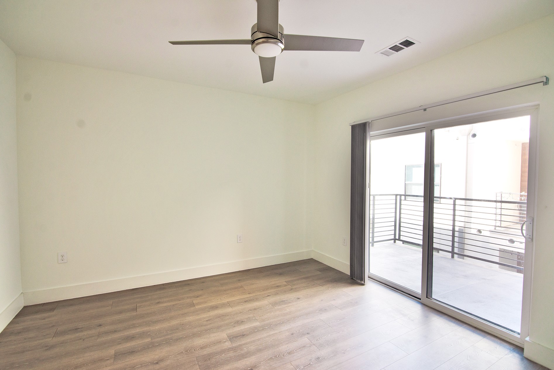 2213 Poquito Street, Unit 313 Austin, TX 78722 - Photo 15 of 26 wooden floor in an empty room with a window