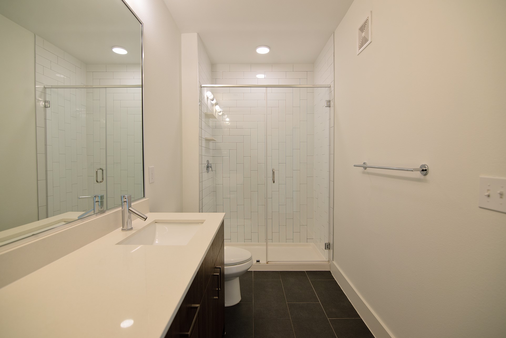 2213 Poquito Street, Unit 313 Austin, TX 78722 - Photo 18 of 26 a bathroom with a sink a shower and a mirror