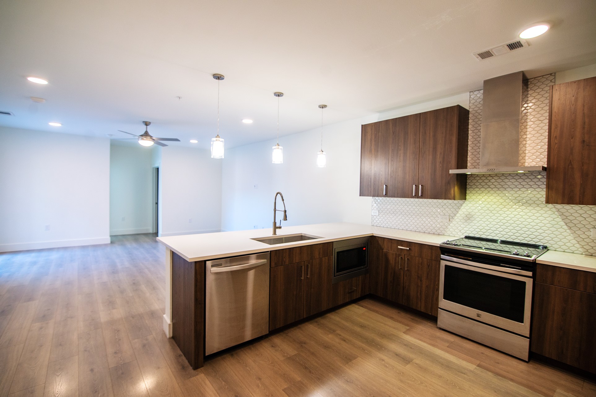 2213 Poquito Street, Unit 313 Austin, TX 78722 - Photo 6 of 26 a kitchen with a sink and a stove top oven