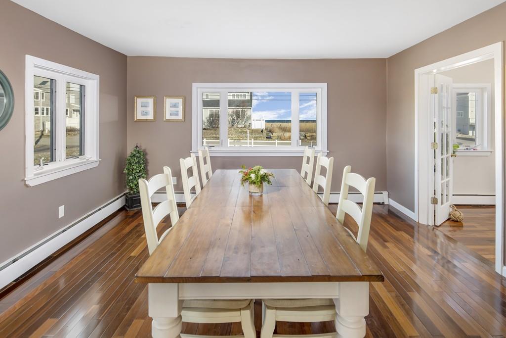 62 Surfside Road Scituate, MA 02066 - Photo 11 of 19 a dining room with wooden floor and large windows