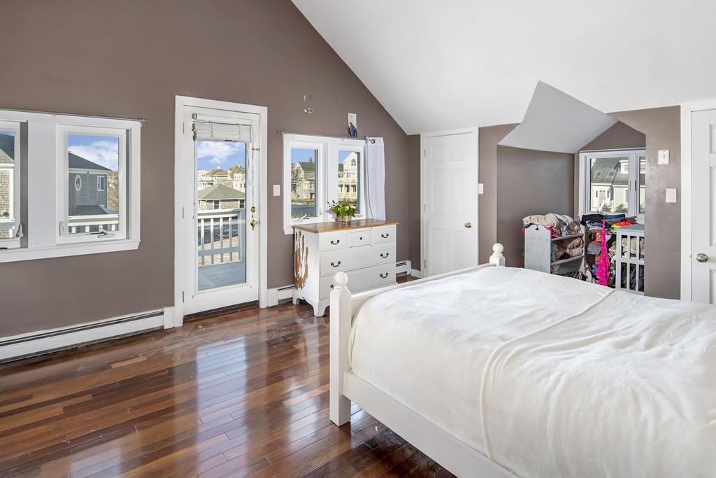 62 Surfside Road Scituate, MA 02066 - Photo 13 of 19 a spacious bedroom with a bed and dresser with wooden floor