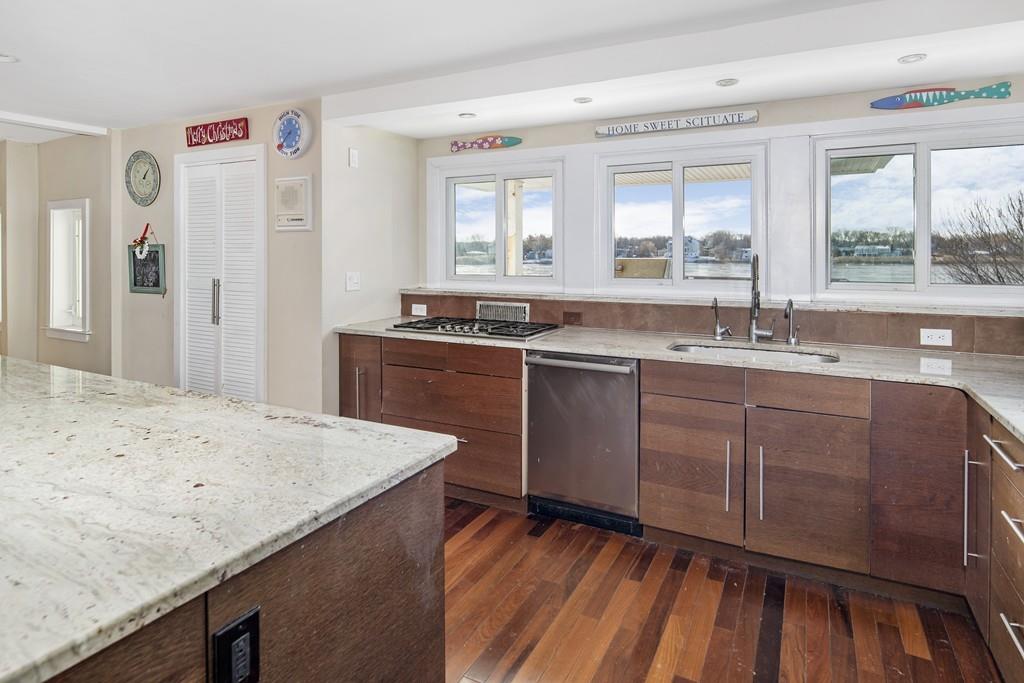 62 Surfside Road Scituate, MA 02066 - Photo 4 of 19 a kitchen with a sink a window and stainless steel appliances