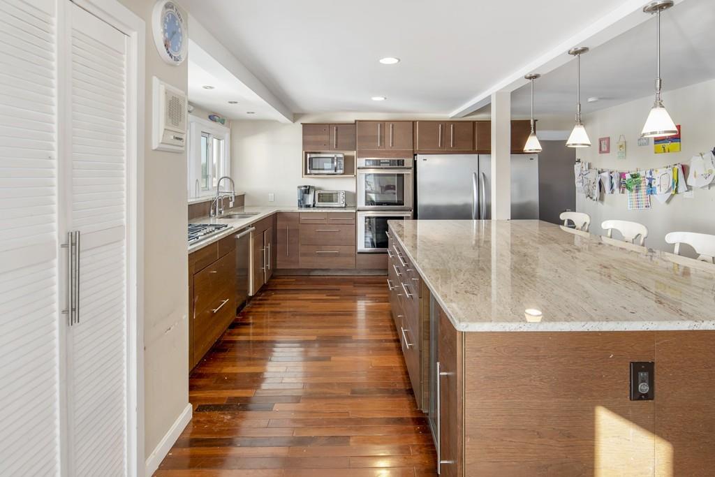 62 Surfside Road Scituate, MA 02066 - Photo 5 of 19 a kitchen with stainless steel appliances granite countertop a sink and stove