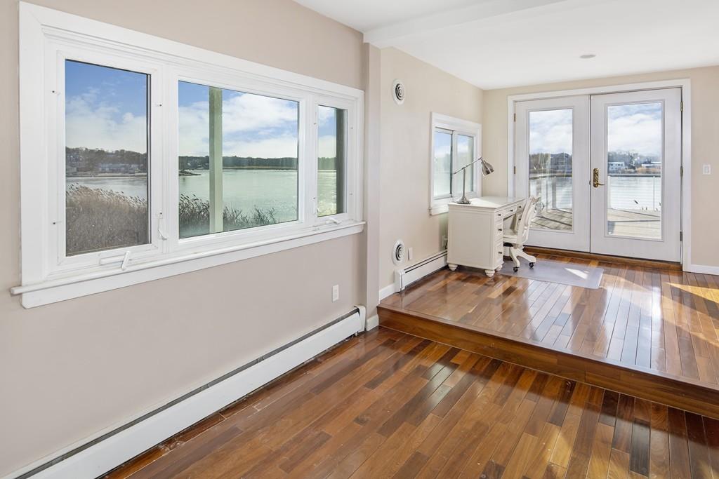 62 Surfside Road Scituate, MA 02066 - Photo 6 of 19 a room with wooden floor and windows