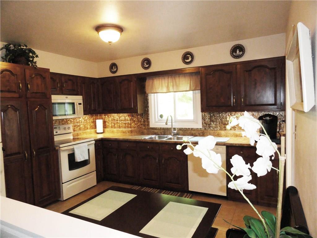 2339 Spicher Hill Road Irwin, PA 15642 - Photo 10 of 25 Spacious kitchen with wood cabinets, updated countertops, new faucet & a complete appliance package