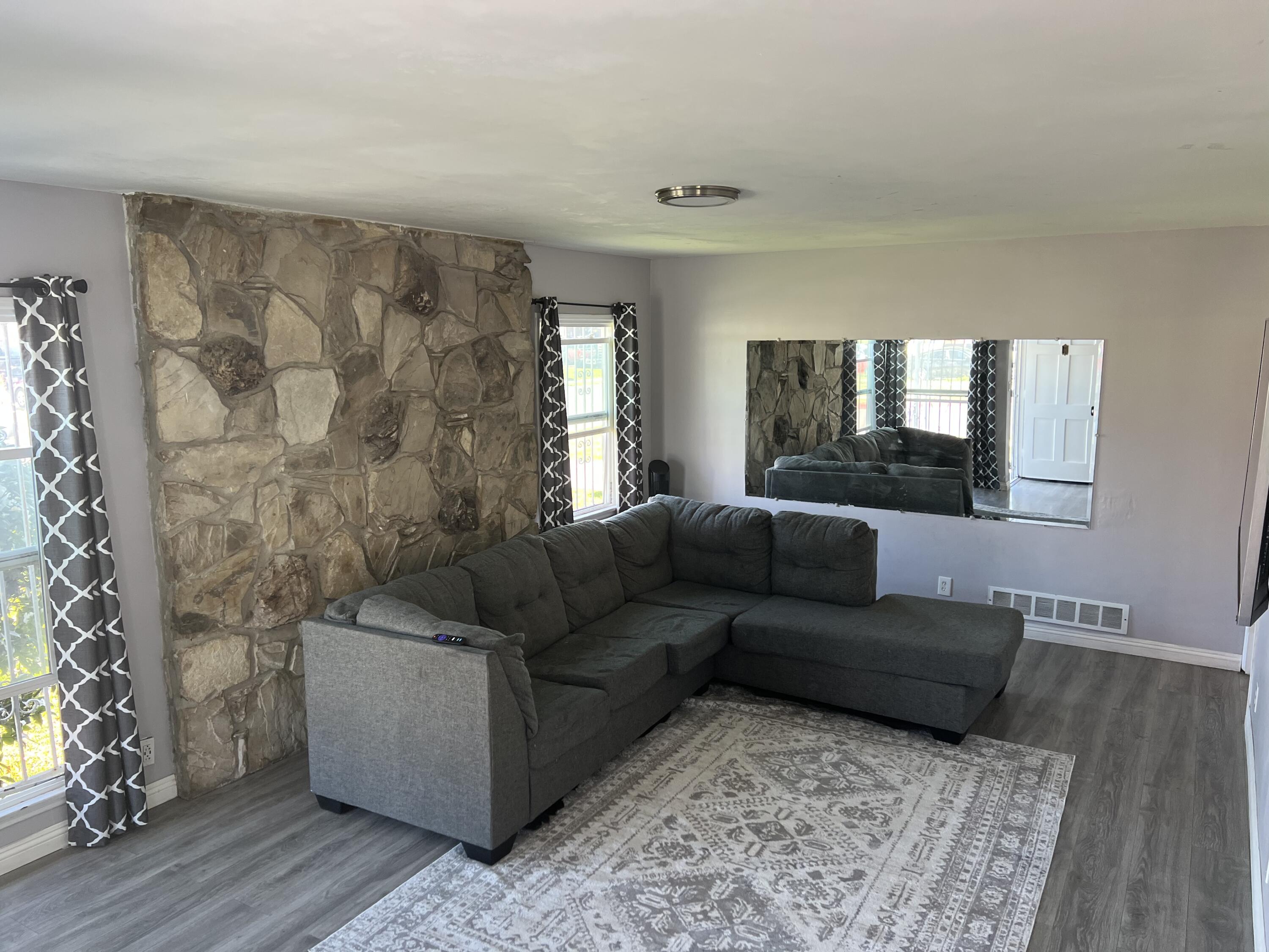 4916 Brompton Avenue Bell, CA 90201 - Photo 12 of 50 a living room with couches and a flat screen tv