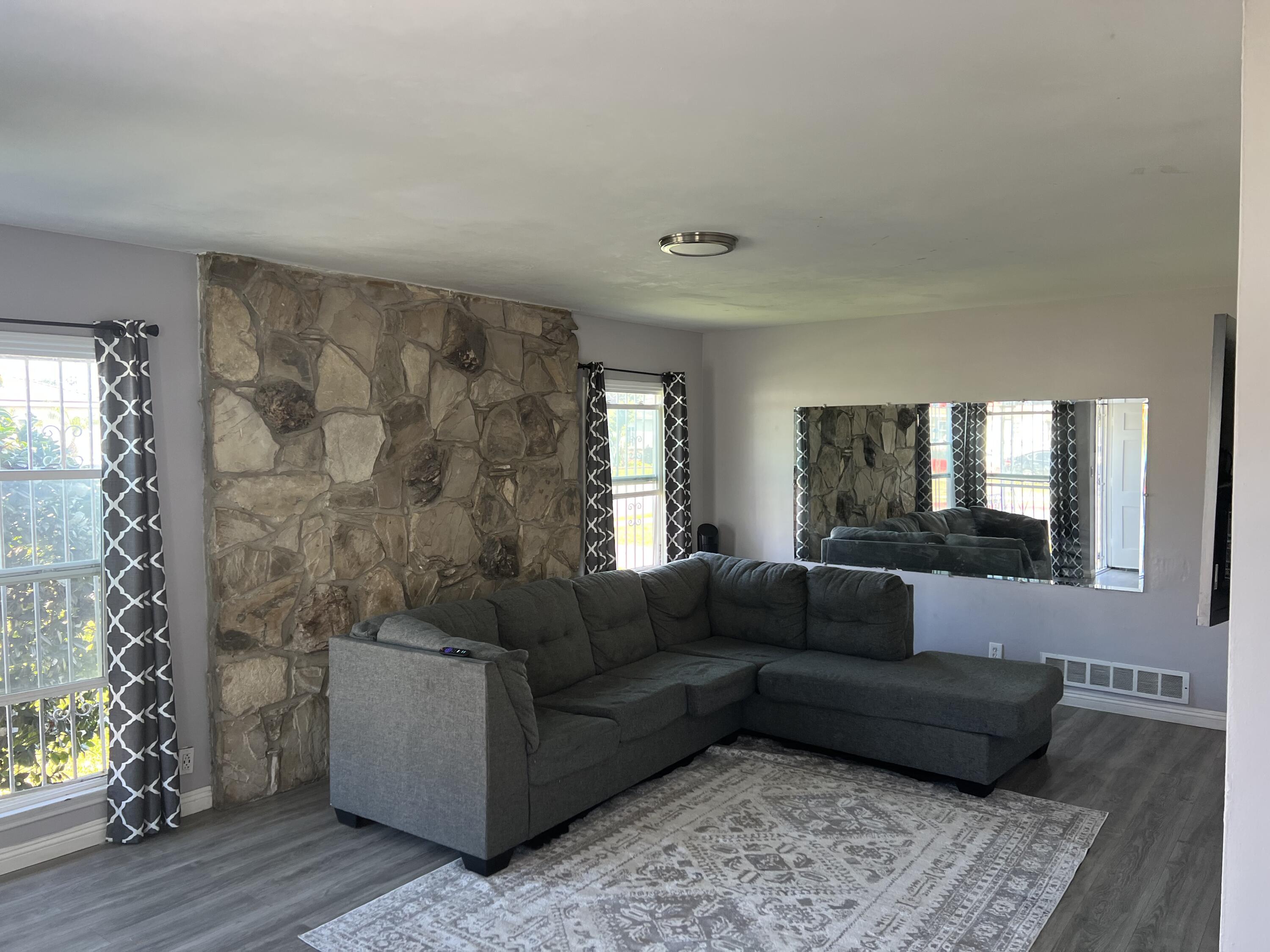 4916 Brompton Avenue Bell, CA 90201 - Photo 13 of 50 a living room with furniture and a window