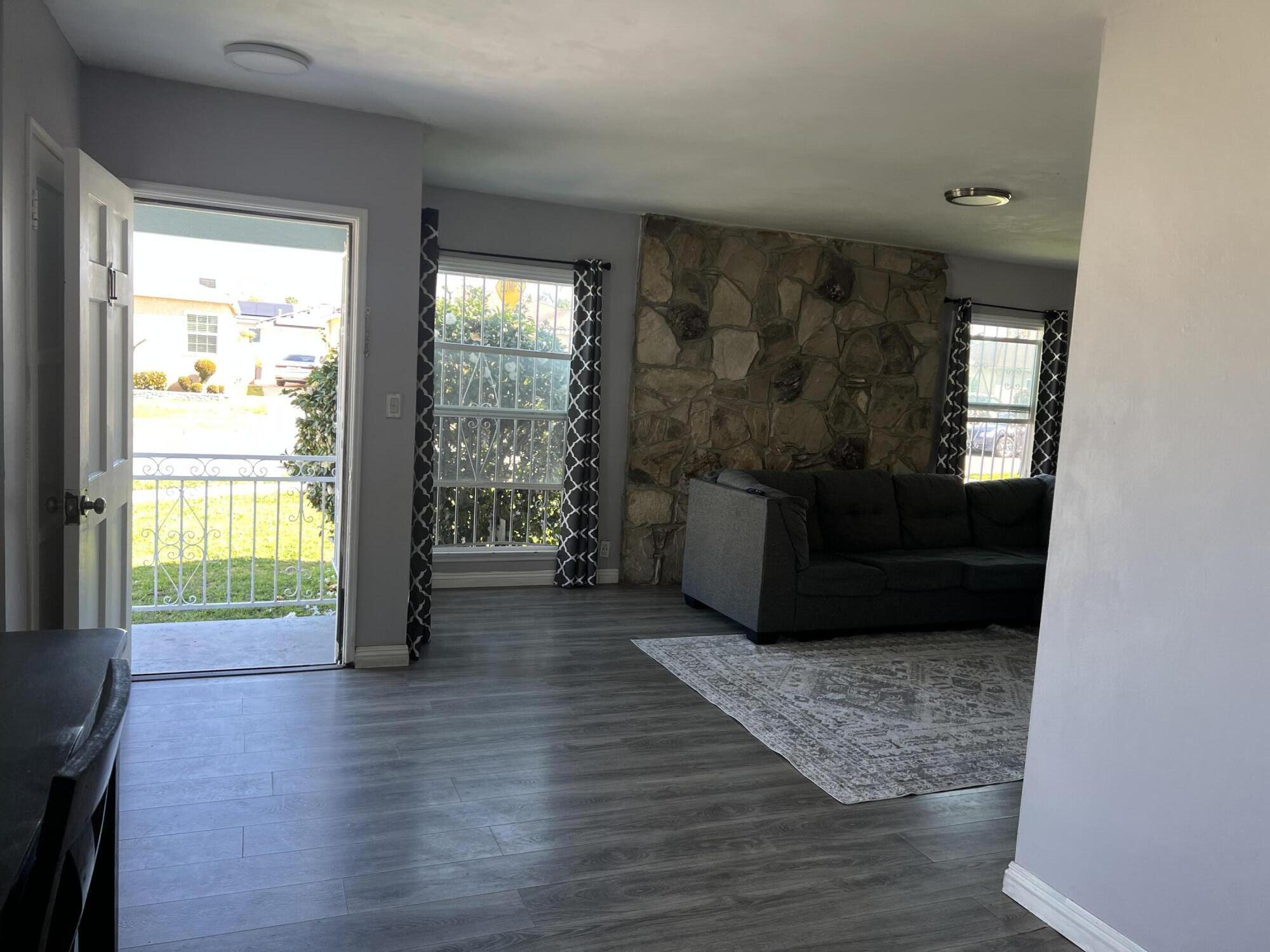 4916 Brompton Avenue Bell, CA 90201 - Photo 14 of 50 a living room with furniture and a large window