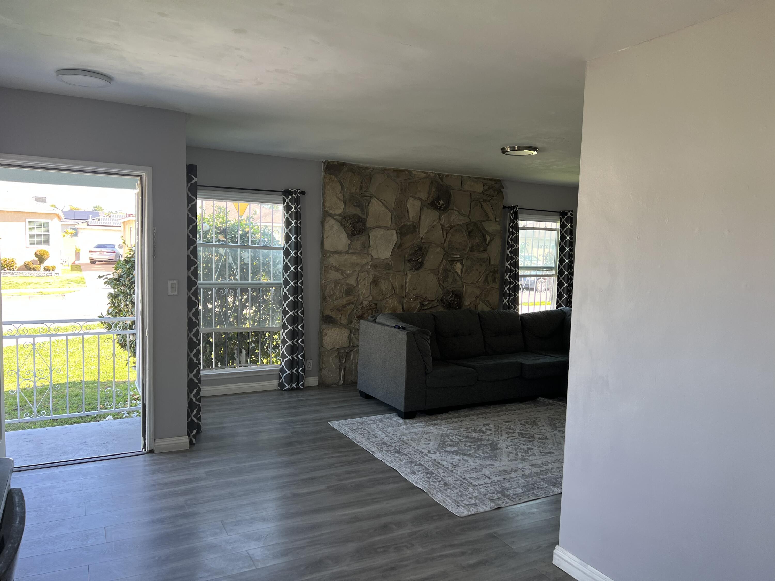 4916 Brompton Avenue Bell, CA 90201 - Photo 15 of 50 a living room with furniture and a window