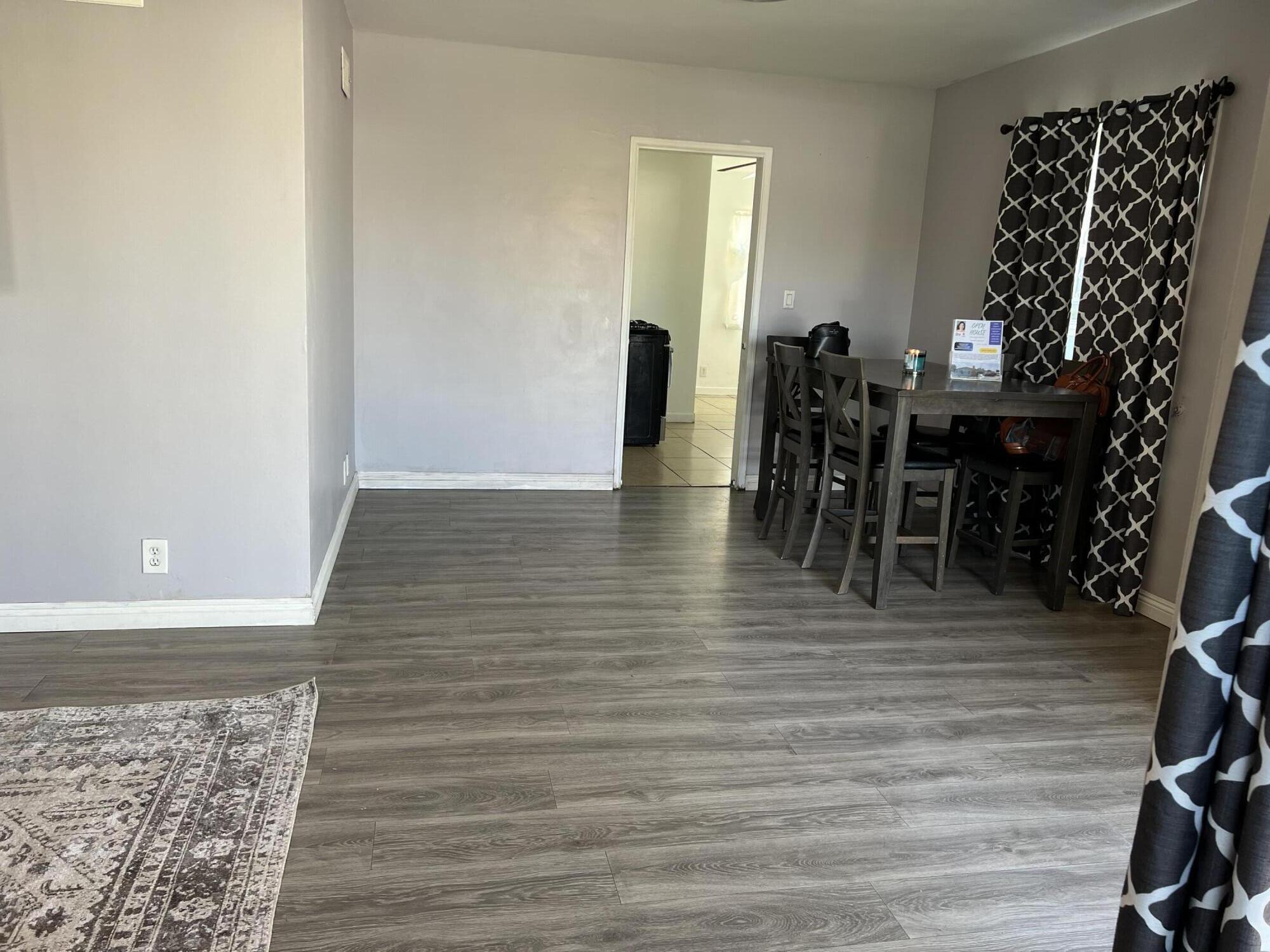 4916 Brompton Avenue Bell, CA 90201 - Photo 17 of 50 a view of a room with furniture and wooden floor