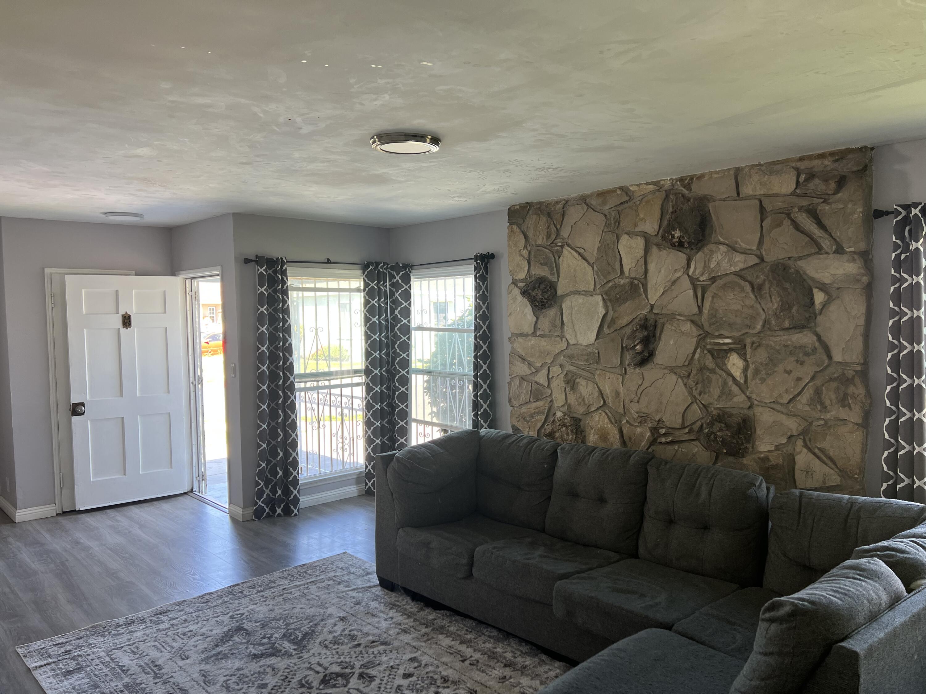 4916 Brompton Avenue Bell, CA 90201 - Photo 2 of 50 a living room with furniture and wooden floor