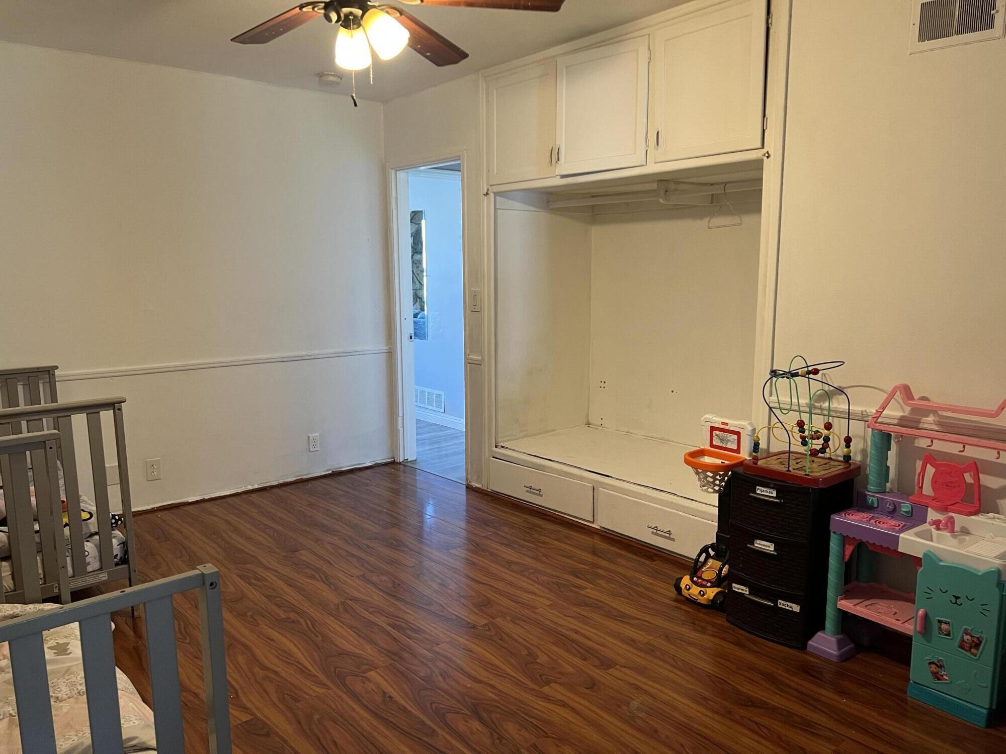 4916 Brompton Avenue Bell, CA 90201 - Photo 24 of 50 a workspace with furniture and wooden floor