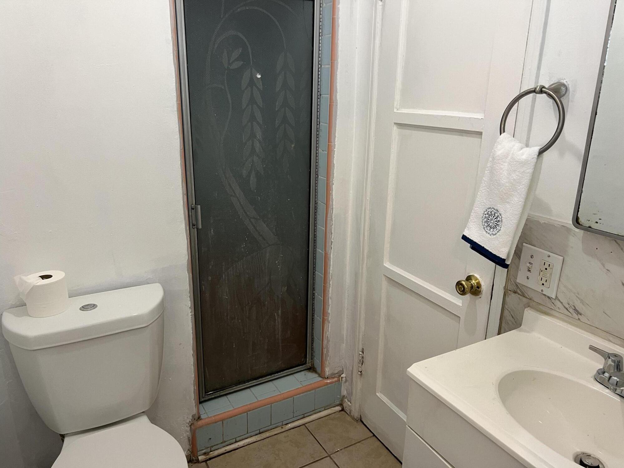 4916 Brompton Avenue Bell, CA 90201 - Photo 25 of 50 a bathroom with a sink toilet and shower